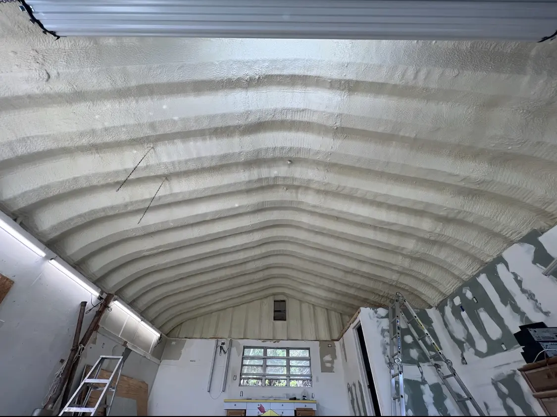 Spray polyurethane foam applied to the underside of a metal roof deck in Grain Valley